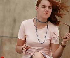 She'd say "oops" if she notice that...wind blows up skirt