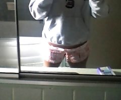 Amazing gadget poses near the mirror and takes off clothes