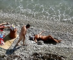 Three sexy ladies sunbathe nude right near the sea